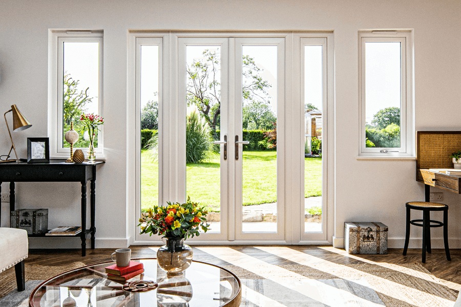 Bright interior with Timberlook French doors overlooking a green garden.